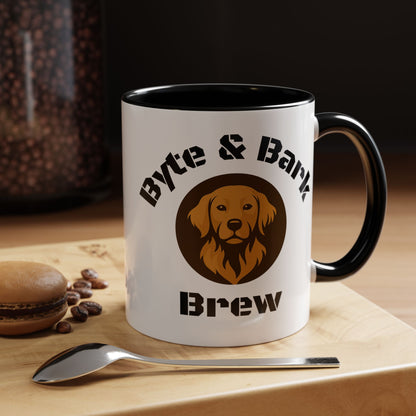 White mug with black interior and handle, featuring a dog logo and text, on a wooden surface with coffee beans and a spoon. 'Byte & Bark Brew'