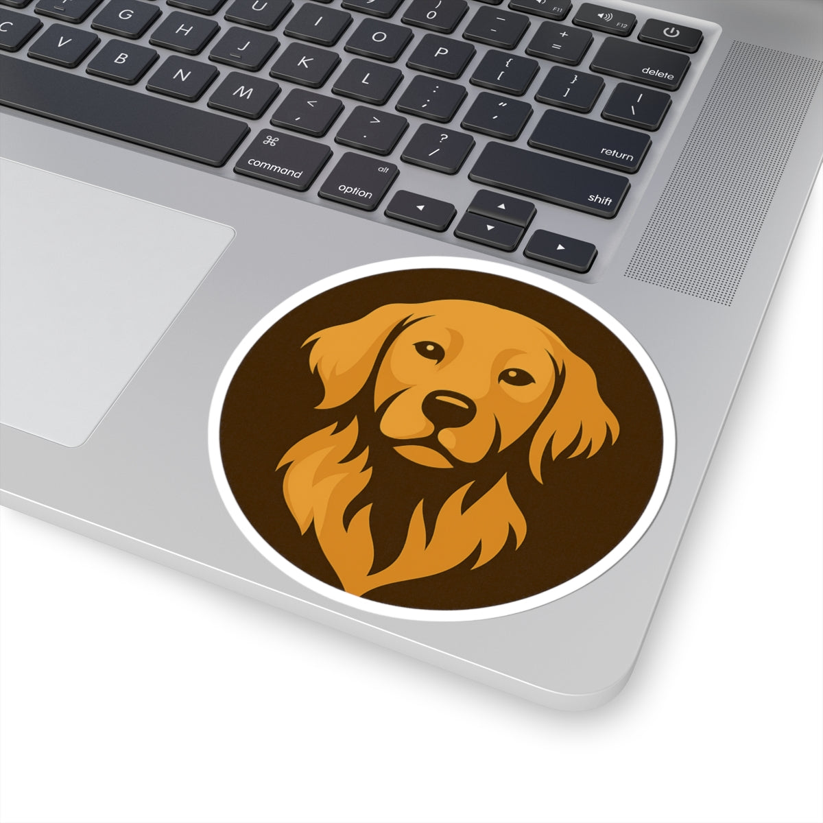 Laptop with a sticker of a dog's face on the palm rest area Byte & Bark Brew sticker