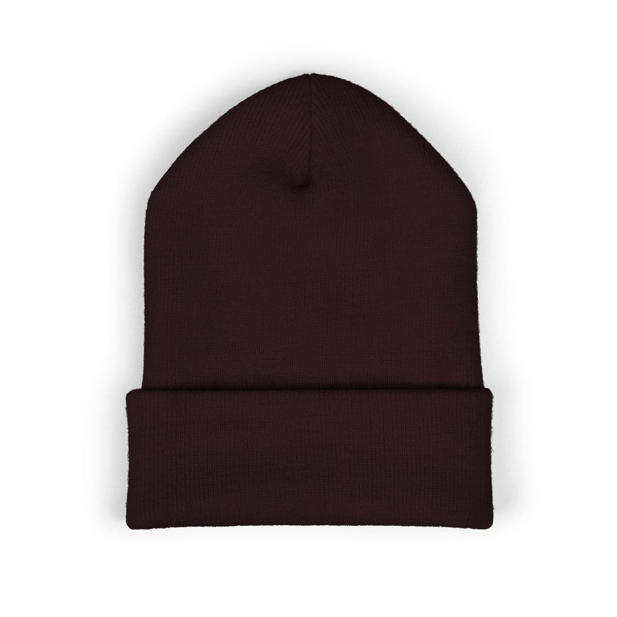 Top-down flat-lay of a folded knit beanie with visible cuff on plain white background