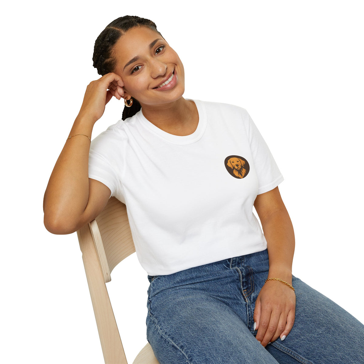 Smiling model seated in white crewneck t-shirt with small round dog emblem on left chest