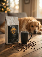 Coffee bag, mug, and scattered coffee beans on a wooden table with a dog in the background.