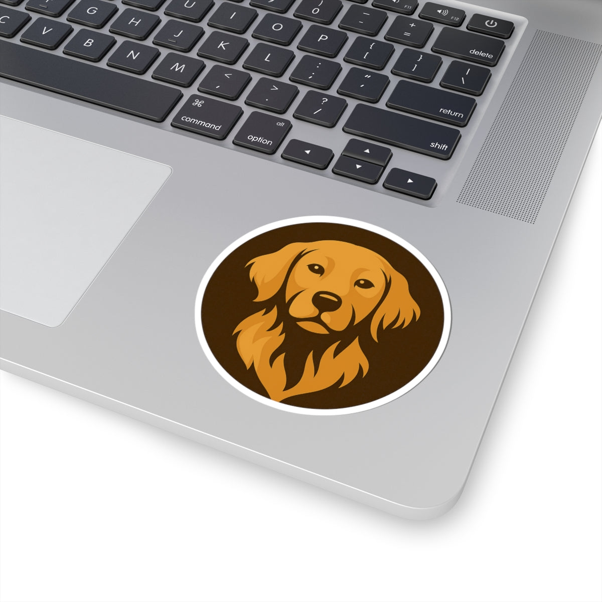Laptop with a sticker of a dog's face on the palm rest area created by Byte and Bark Brew