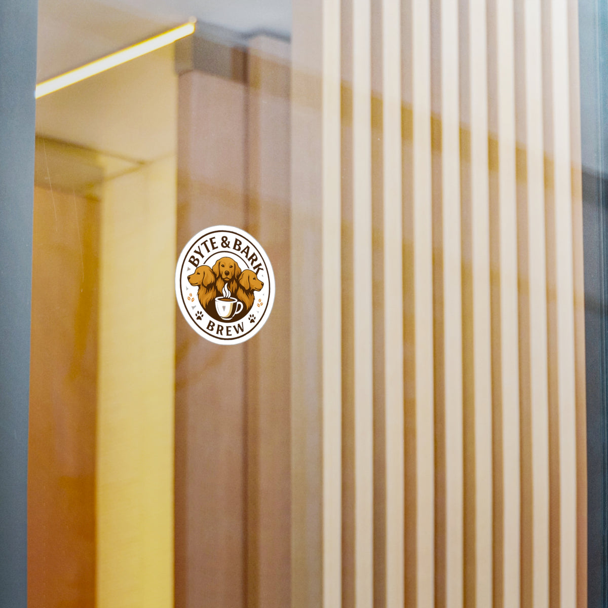 Byte & Bark Brew® round sticker showing three dog heads above a steaming coffee cup on glass