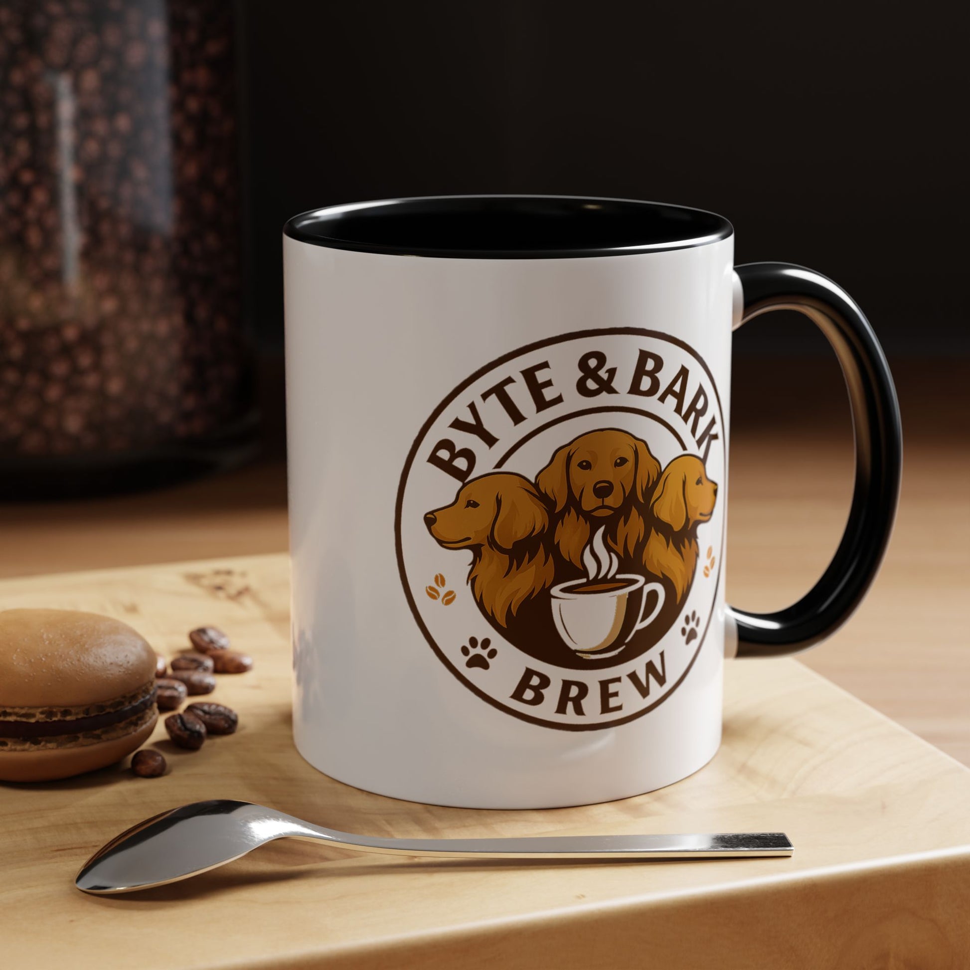 White mug with black interior and handle, featuring 'Byte & Bark Brew' logo on a wooden surface with coffee beans and a spoon.