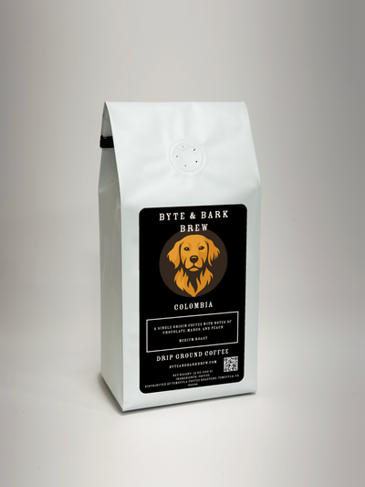 A white bag of Byte & Bark Brew 6-Bean Blend coffee with a black label featuring an orange dog illustration, photographed on a neutral light gray background.