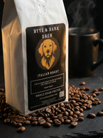 Byte & Bark Brew Italian Roast coffee bag with coffee beans on a dark surface