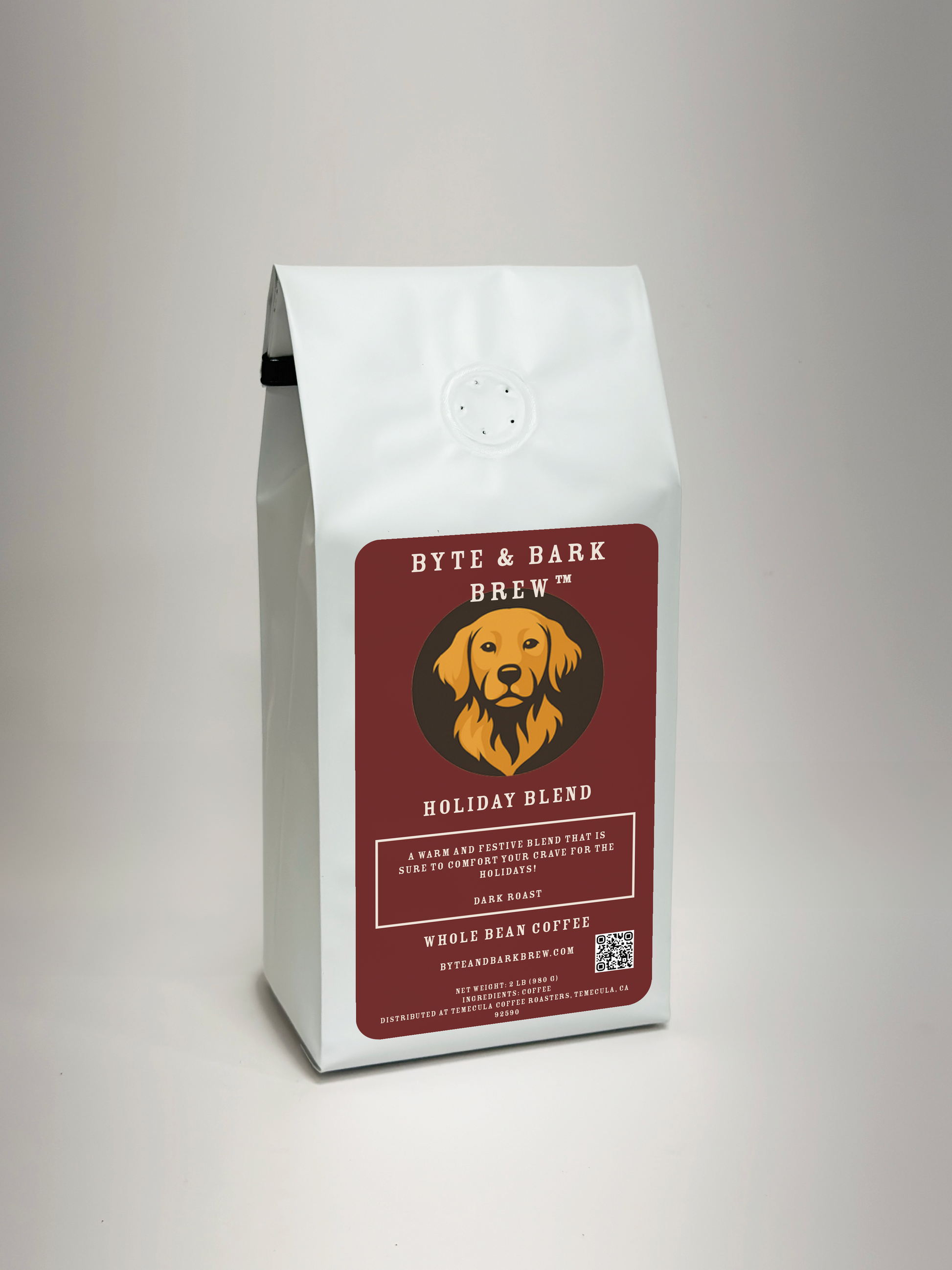 Byte & Bark Brew Holiday Coffee Blend. White coffee bag with a red label featuring a dog illustration on a gray background