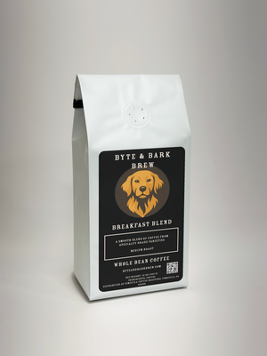 A white bag of Byte & Bark Brew Breakfast Blend coffee, featuring a black label with a golden retriever logo, photographed on a light gray background.