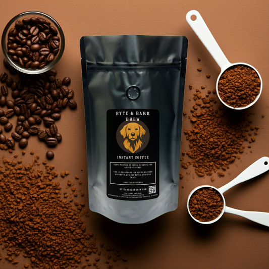 Byte & Bark Brew Instant Coffee bag surrounded by tablespoons of coffee and a glass container filled with coffee beans.